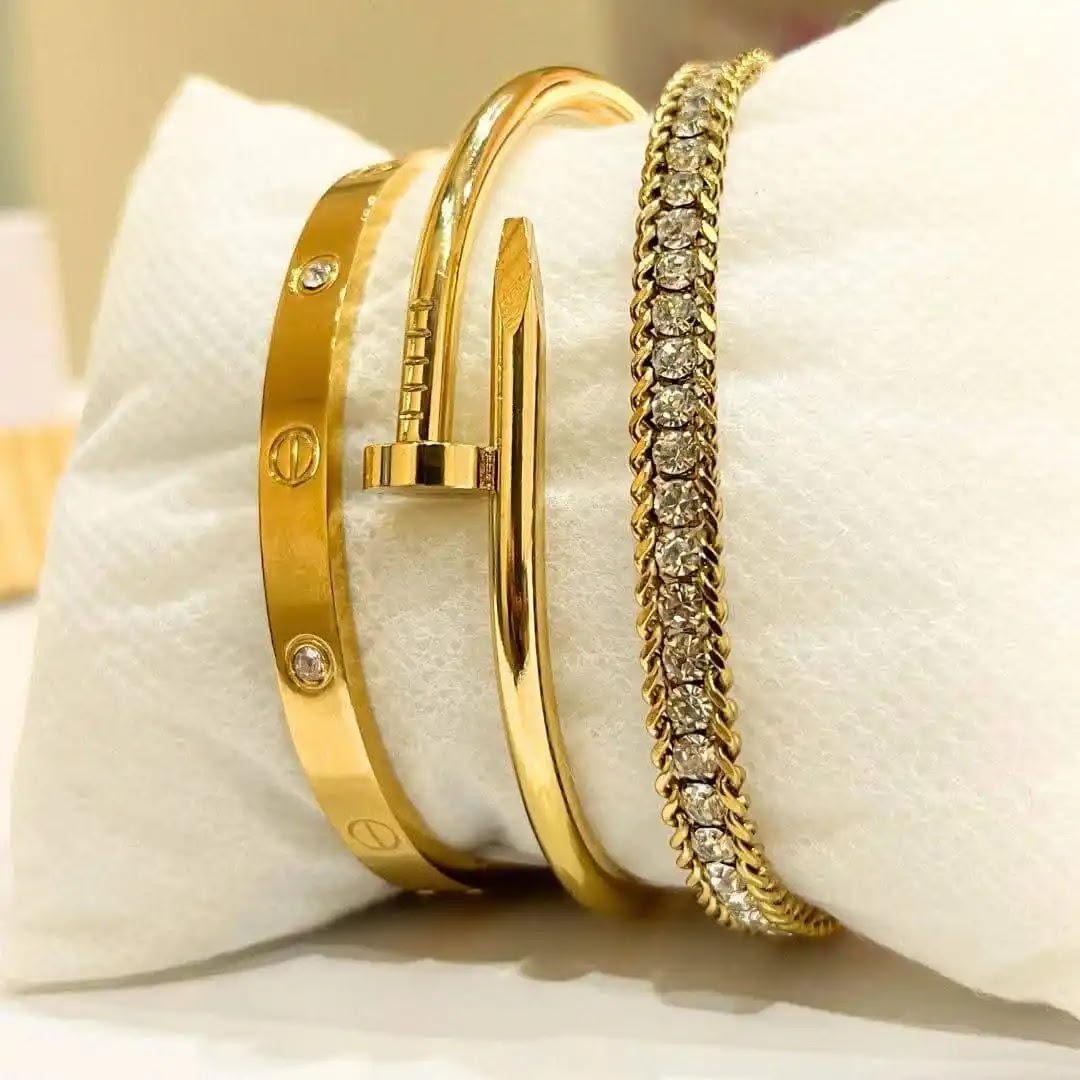 Model wearing gold mesh bracelet with white outfit at desk